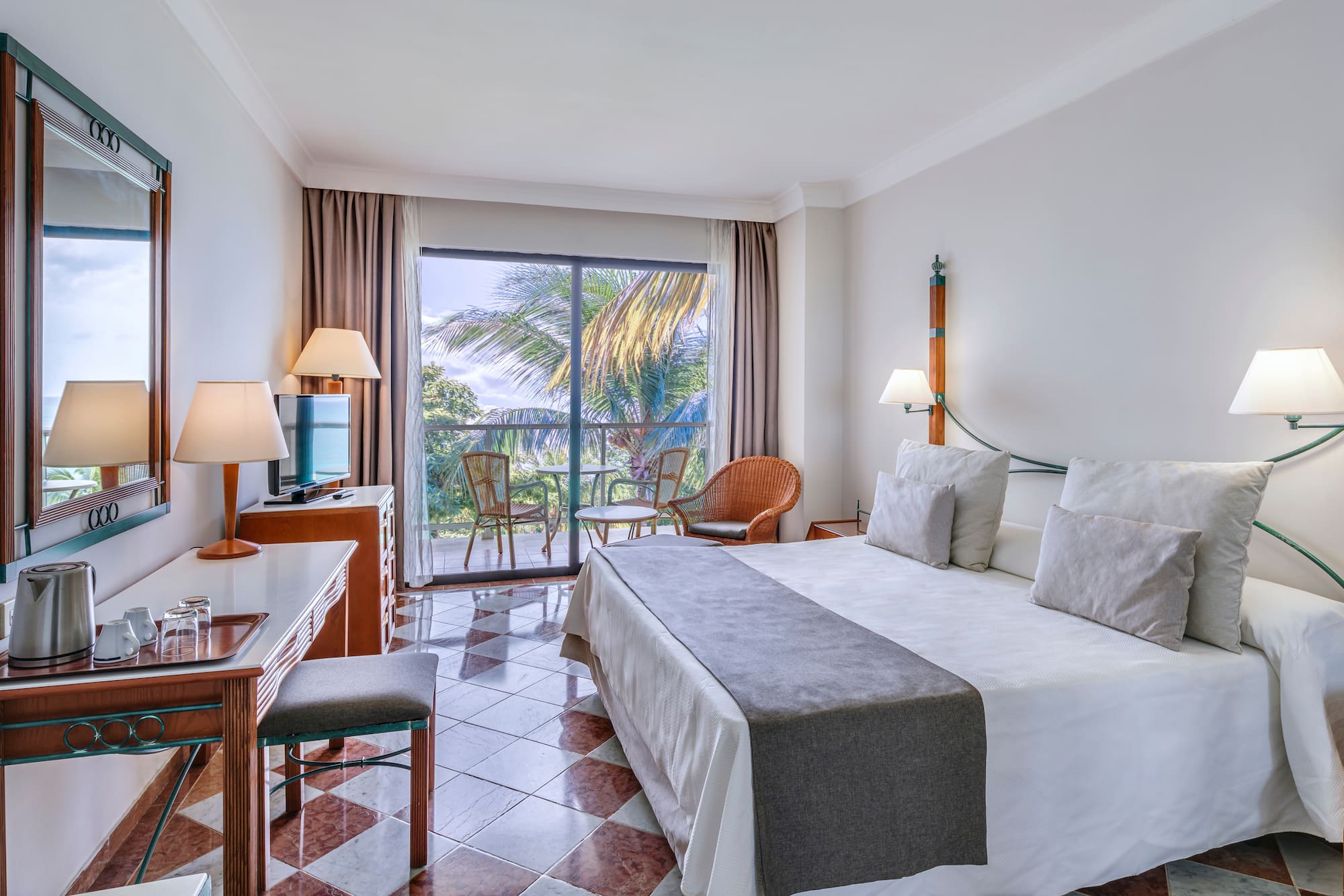 a room with a bed and a table and chairs