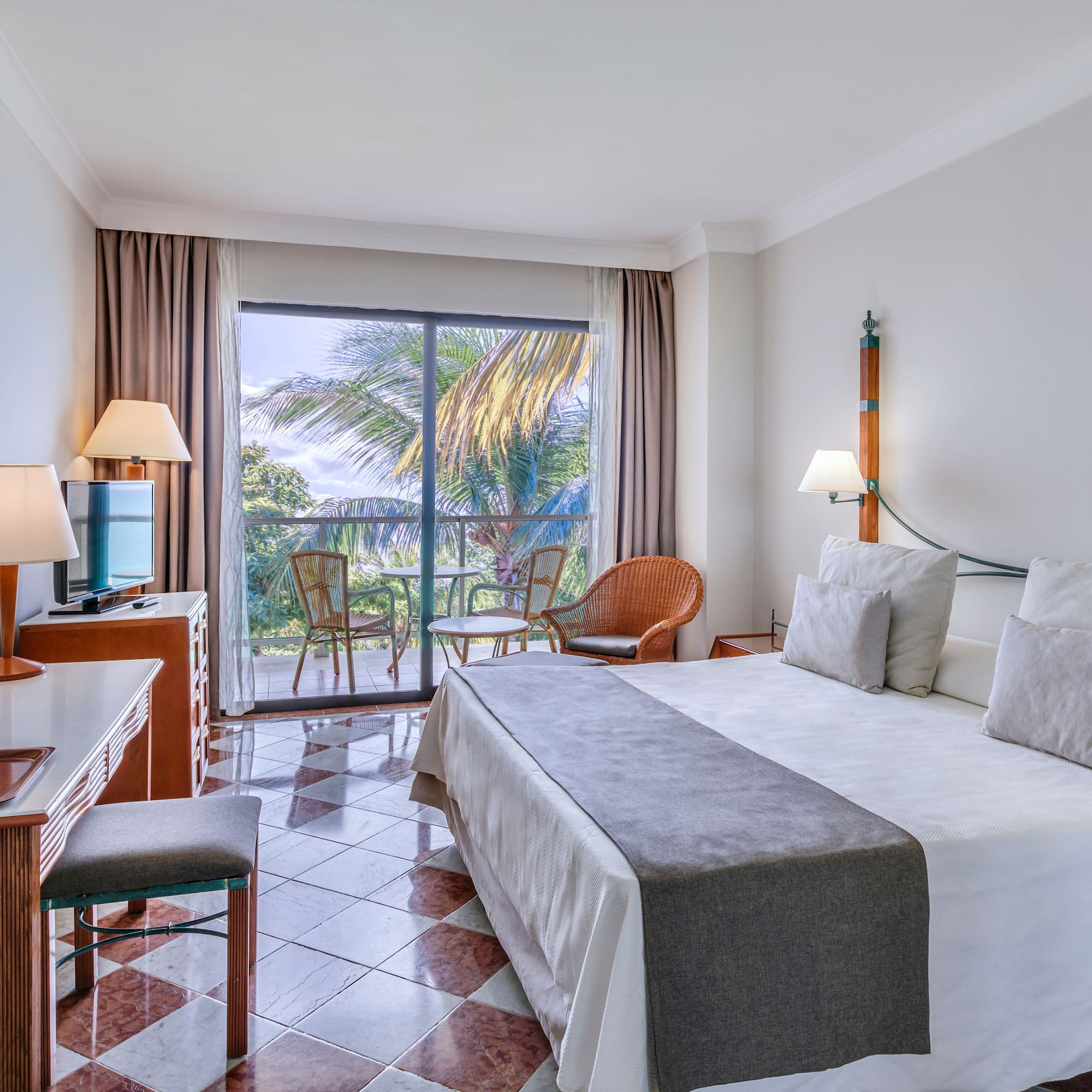 a room with a bed and a table and chairs