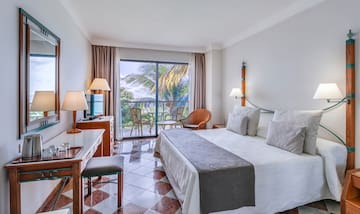 a room with a bed and a table and chairs