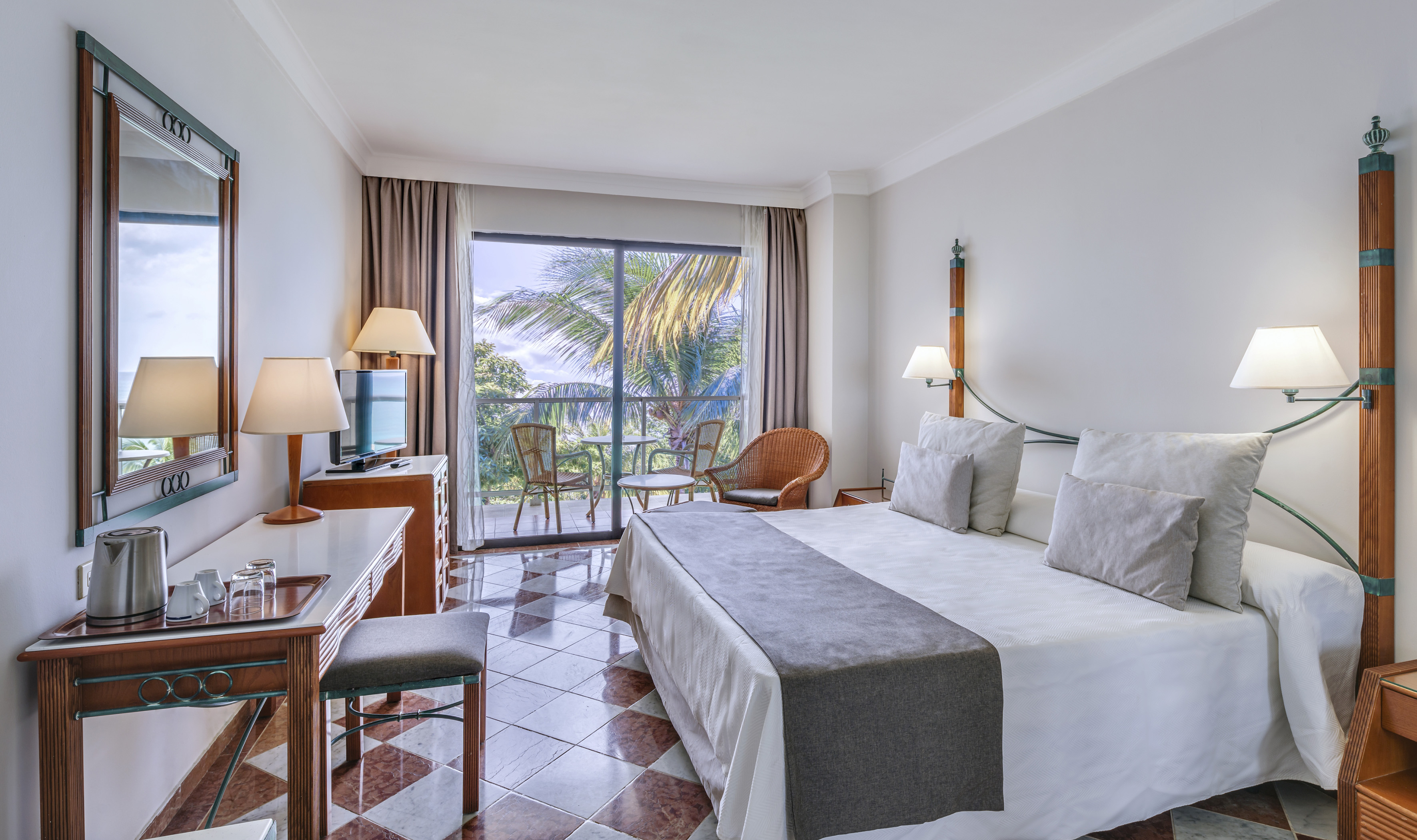 a room with a bed and a table and chairs