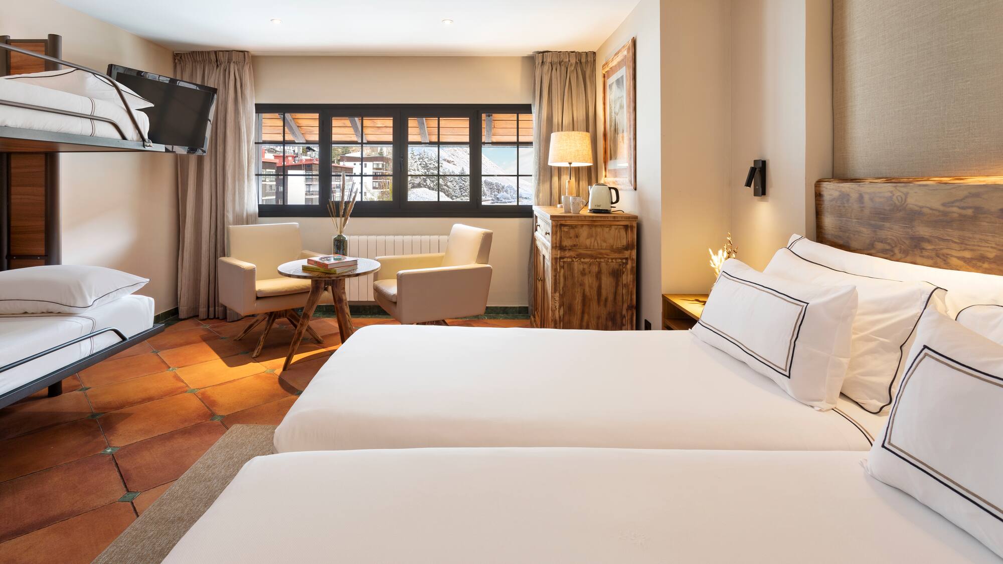 a room with two beds and a television