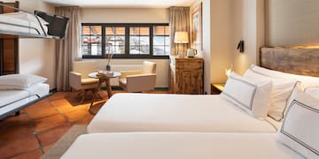 a room with two beds and a television