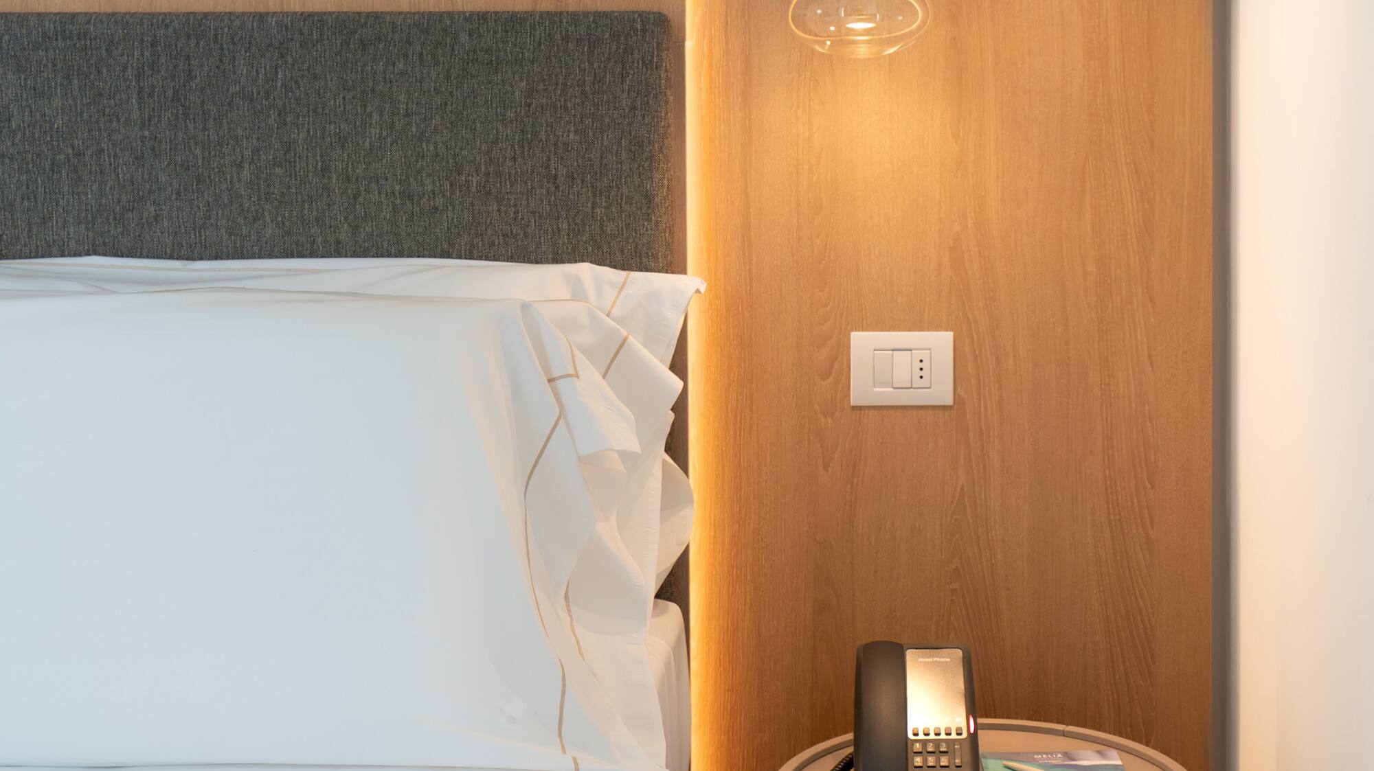 a bed with a telephone and a table