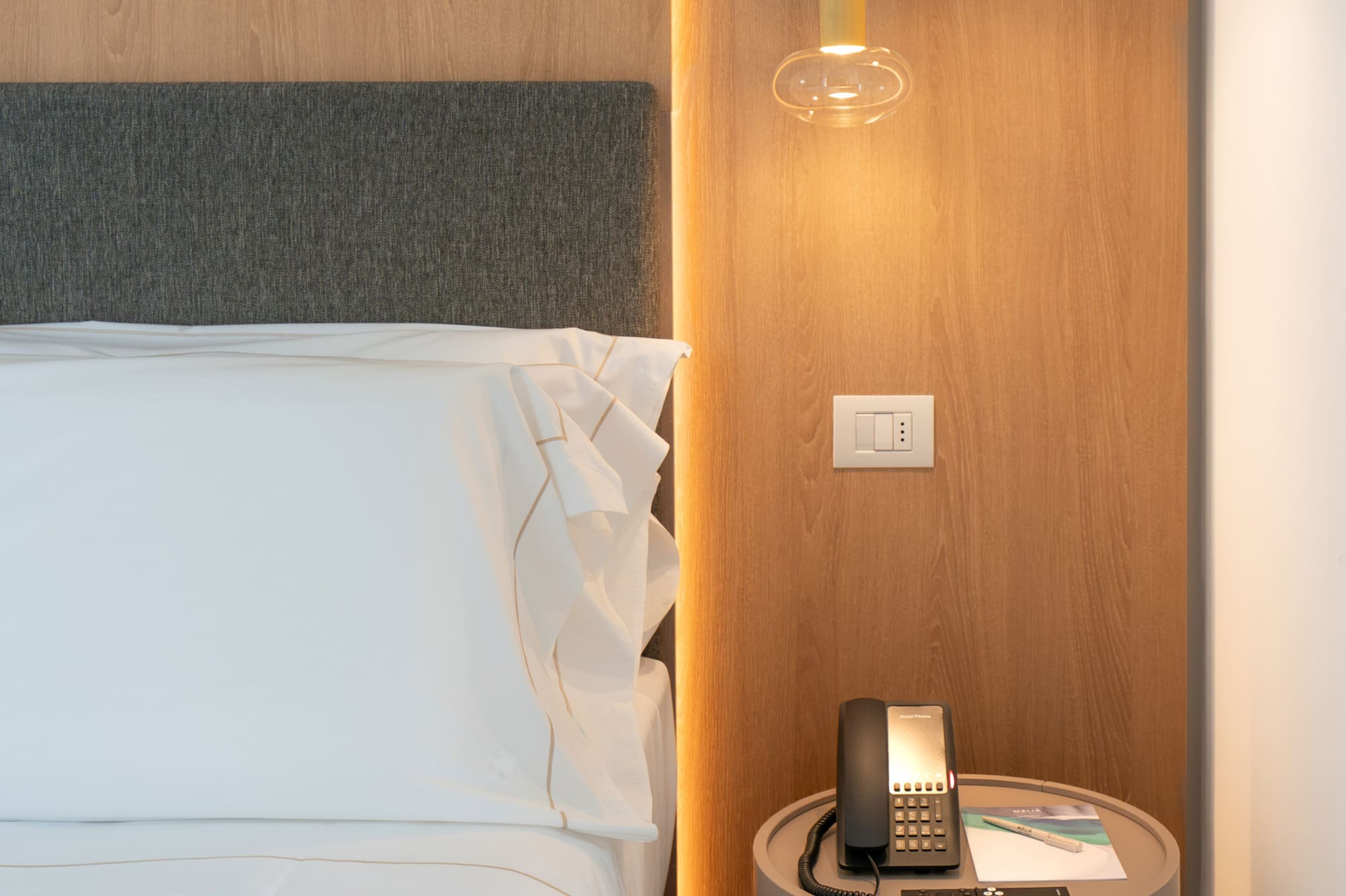 a bed with a telephone and a table