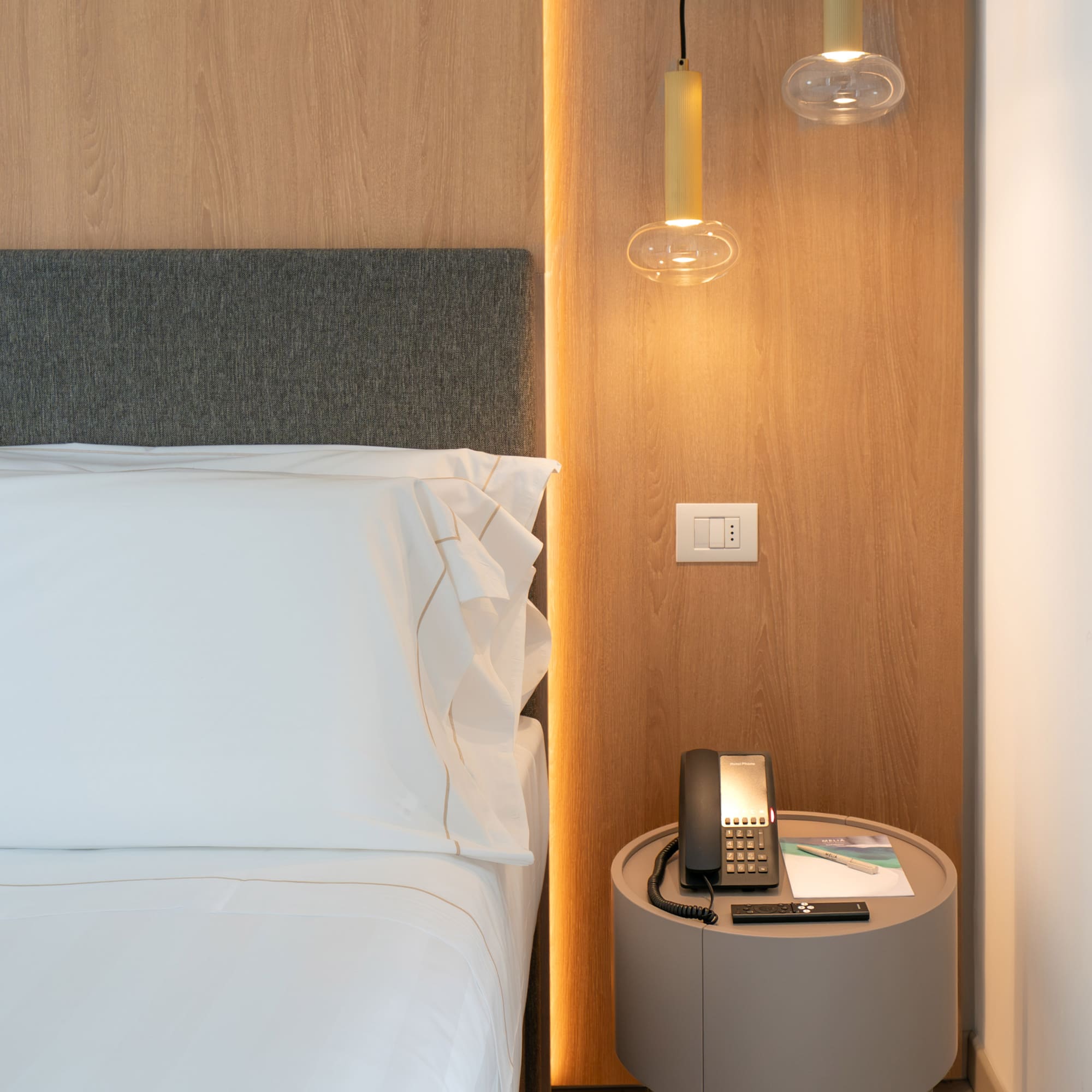 a bed with a telephone and a table