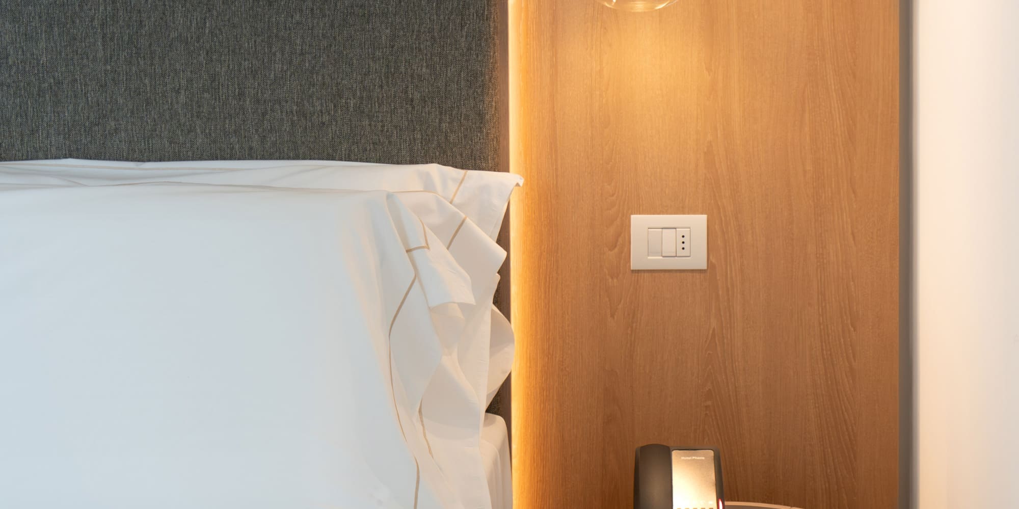 a bed with a telephone and a table