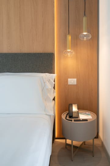 a bed with a telephone and a table