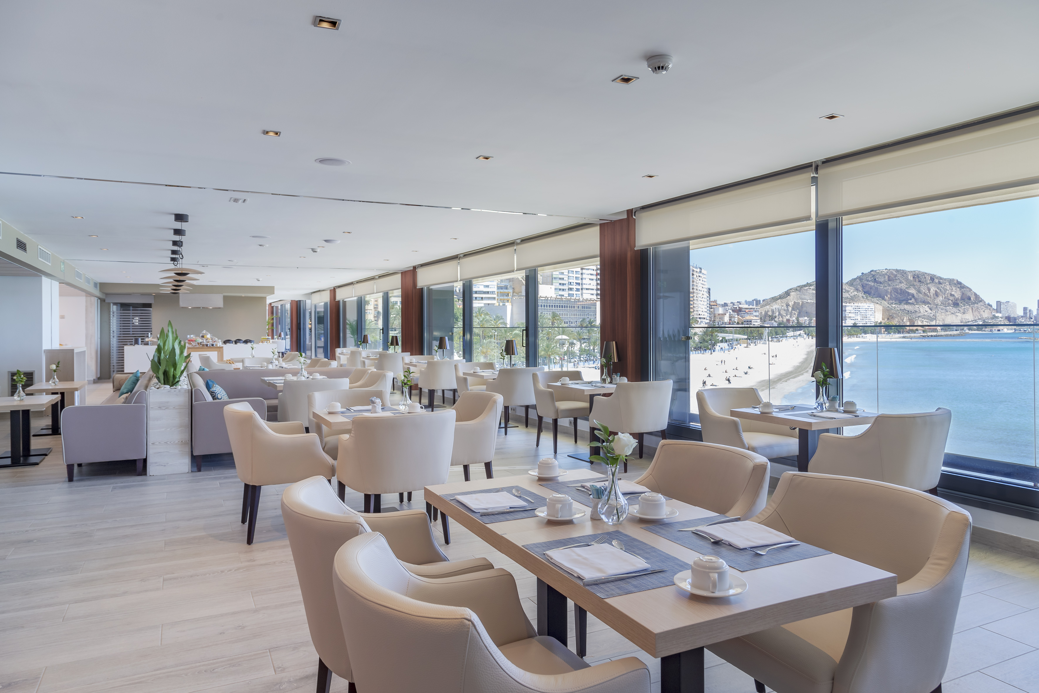 Modern restaurant with panoramic ocean and beach views.
