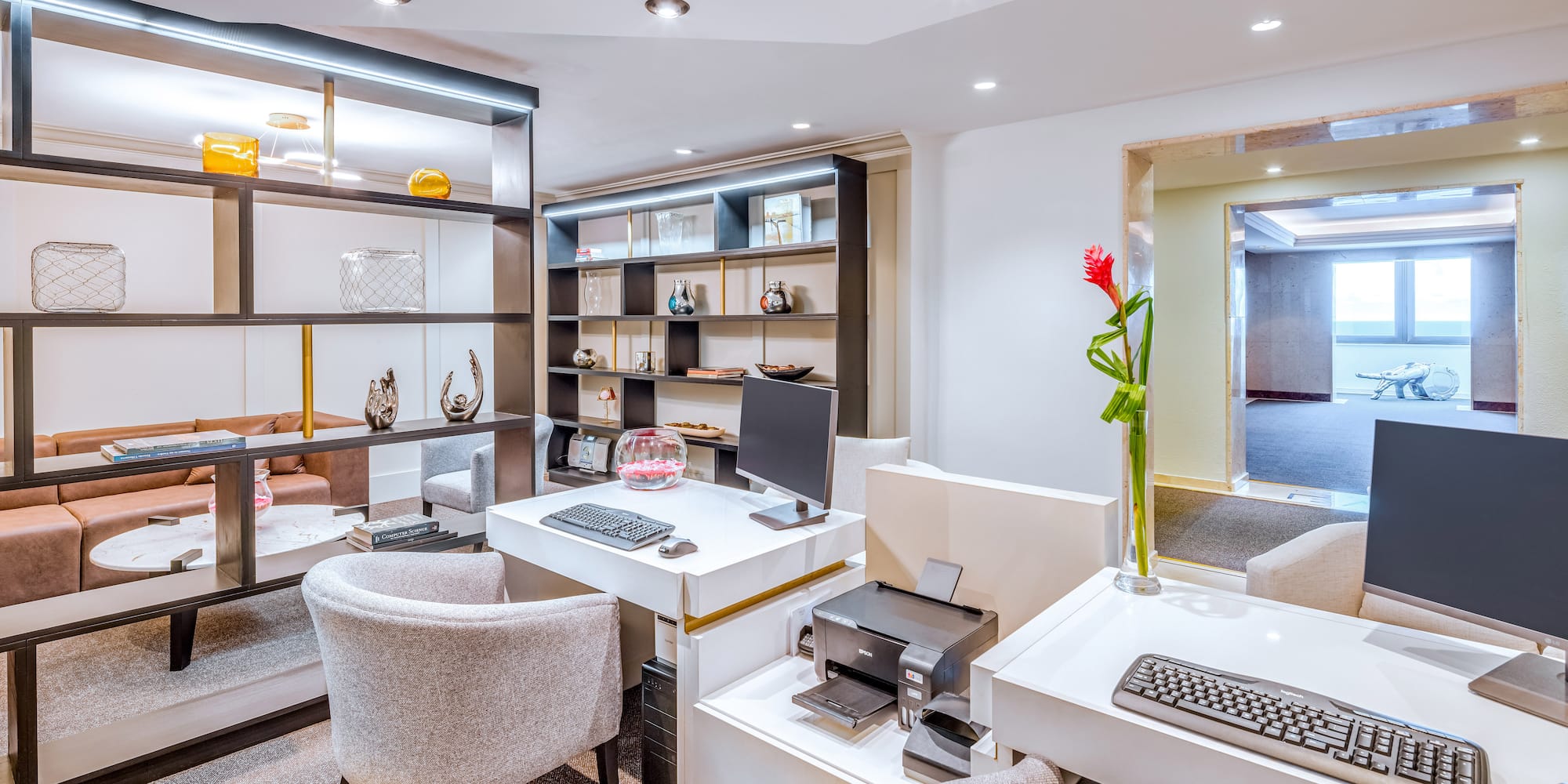 a room with white walls and a computer desk