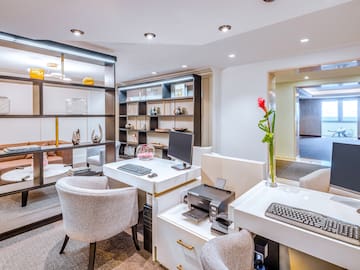 a room with white walls and a computer desk