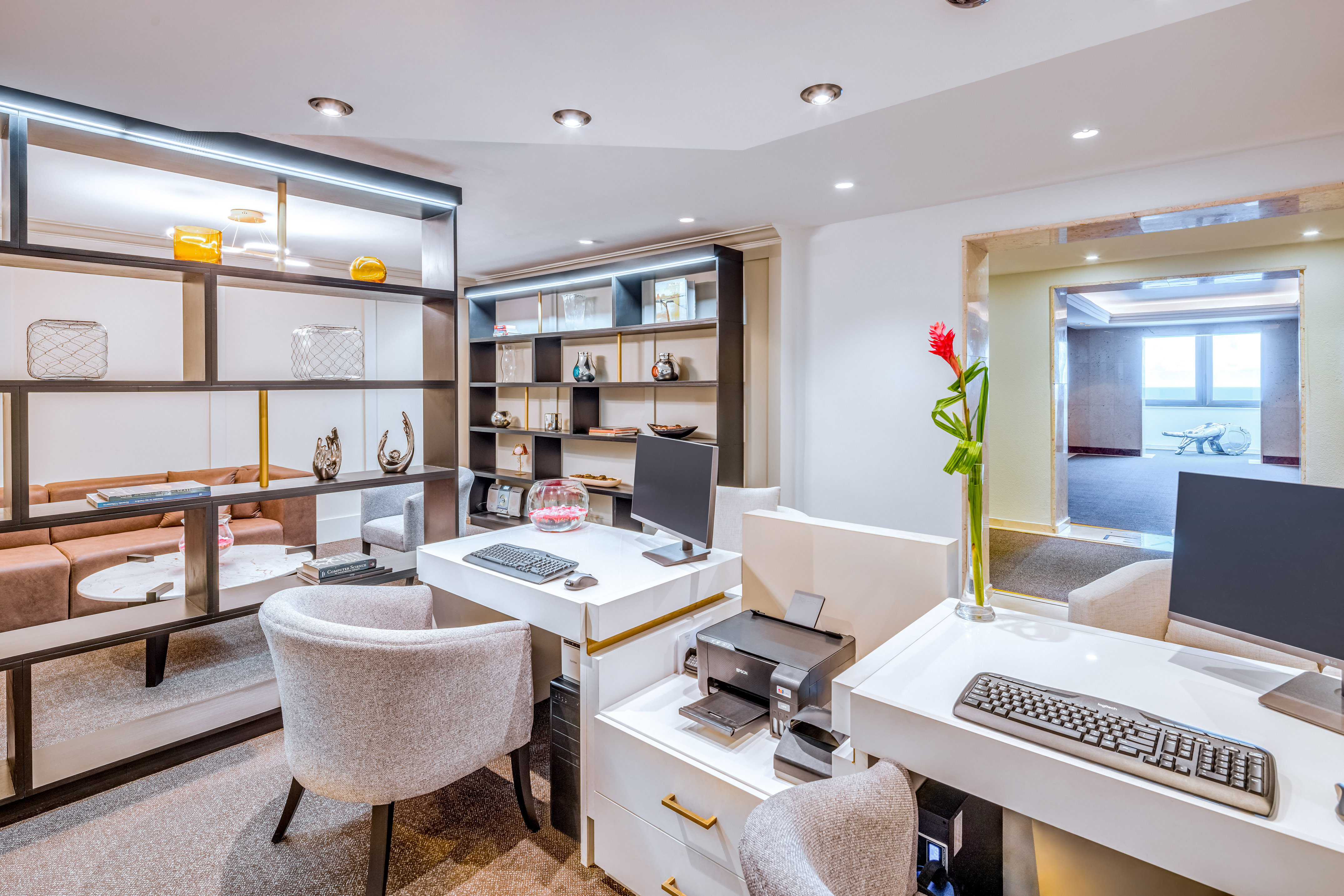 a room with white walls and a computer desk