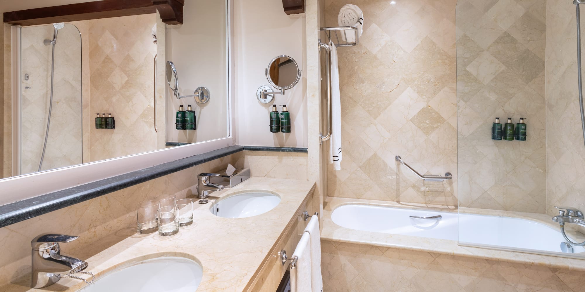 a bathroom with marble countertops and a bathtub