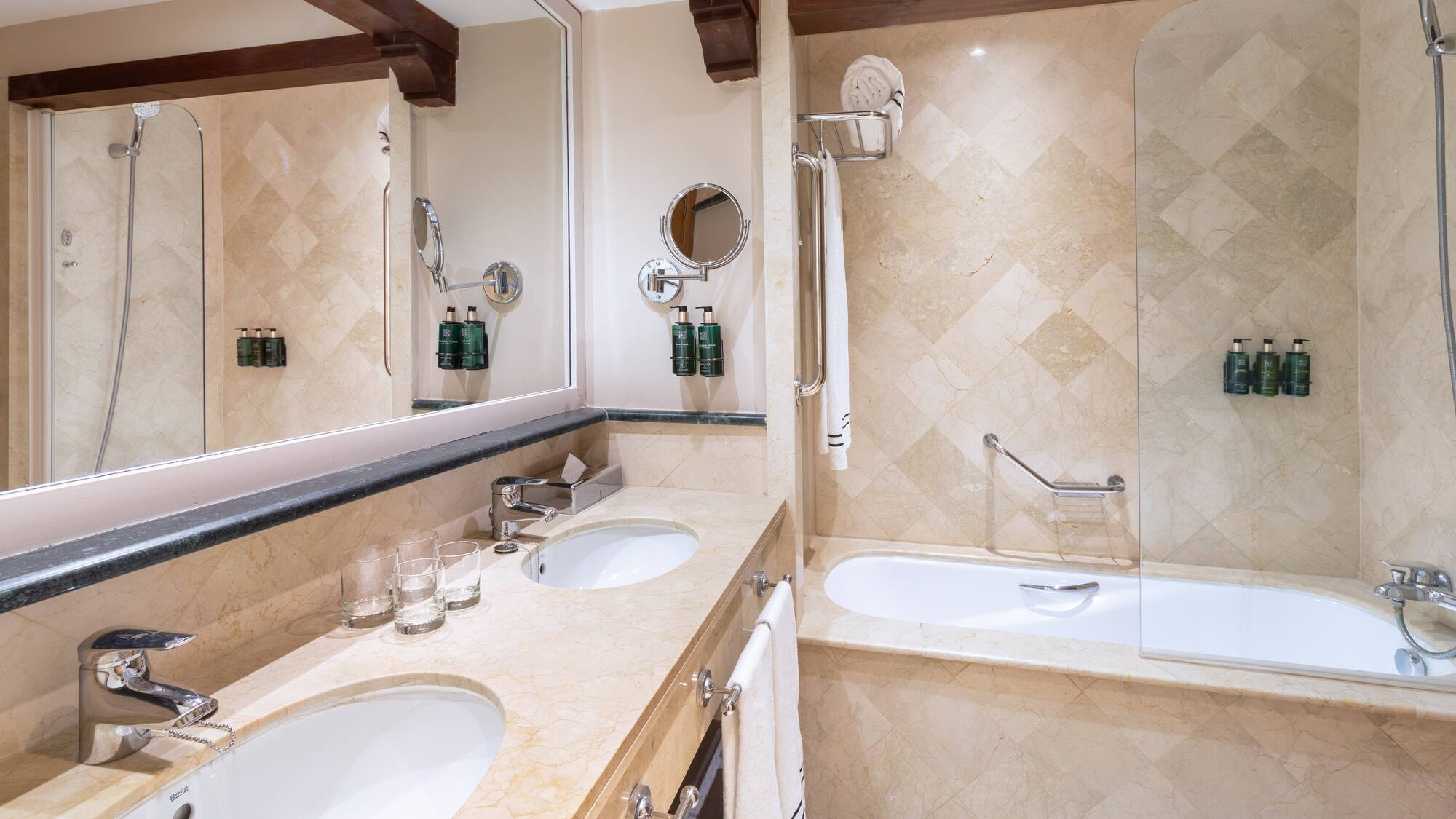 a bathroom with marble countertops and a tub
