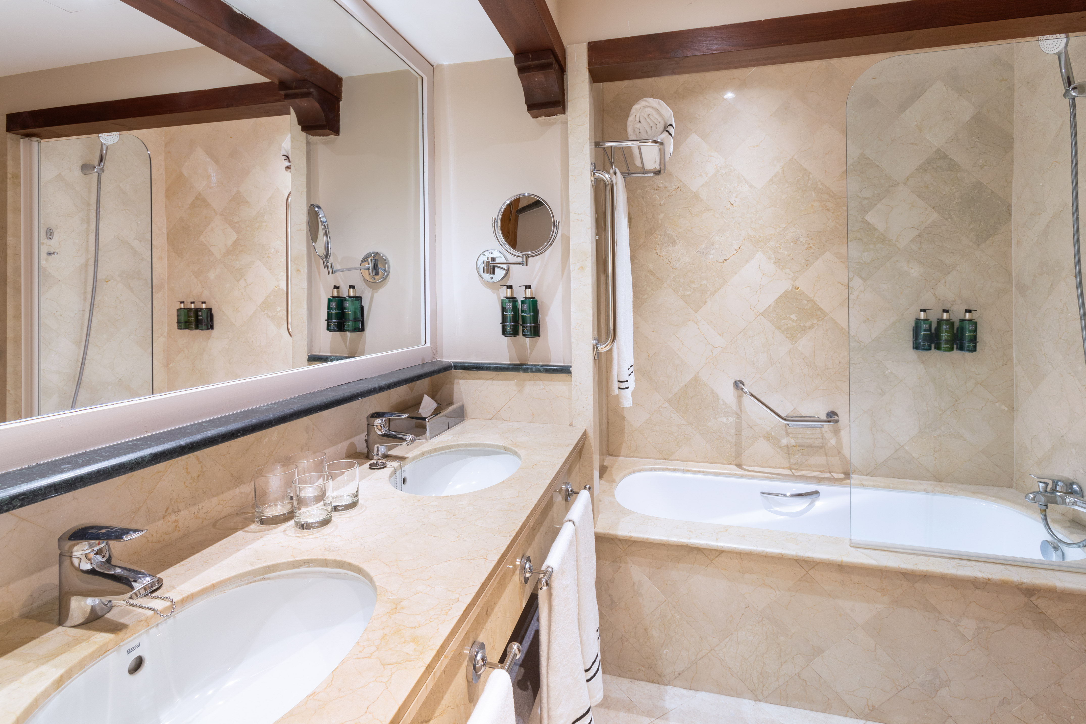 a bathroom with marble countertops and a tub