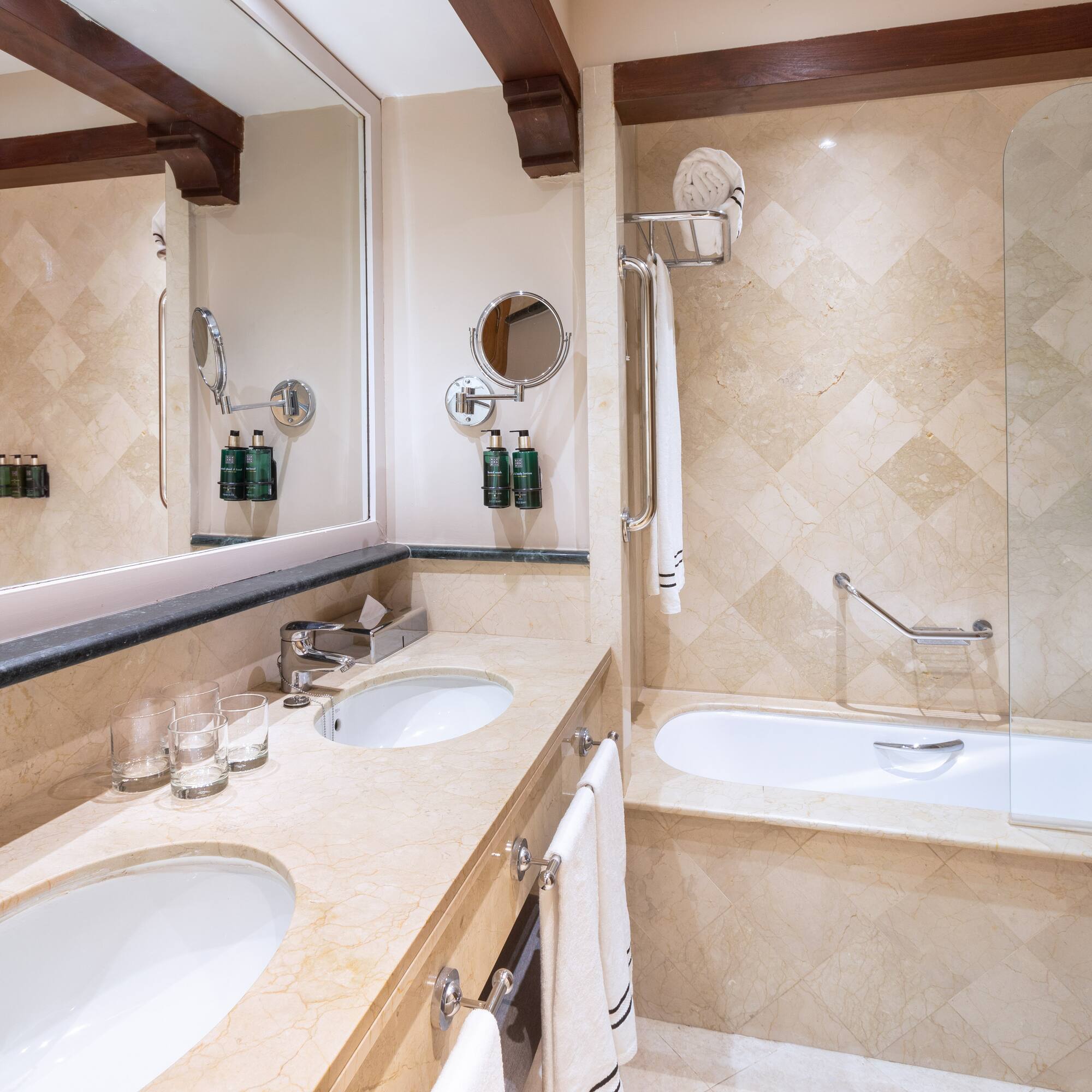 a bathroom with marble countertops and a tub