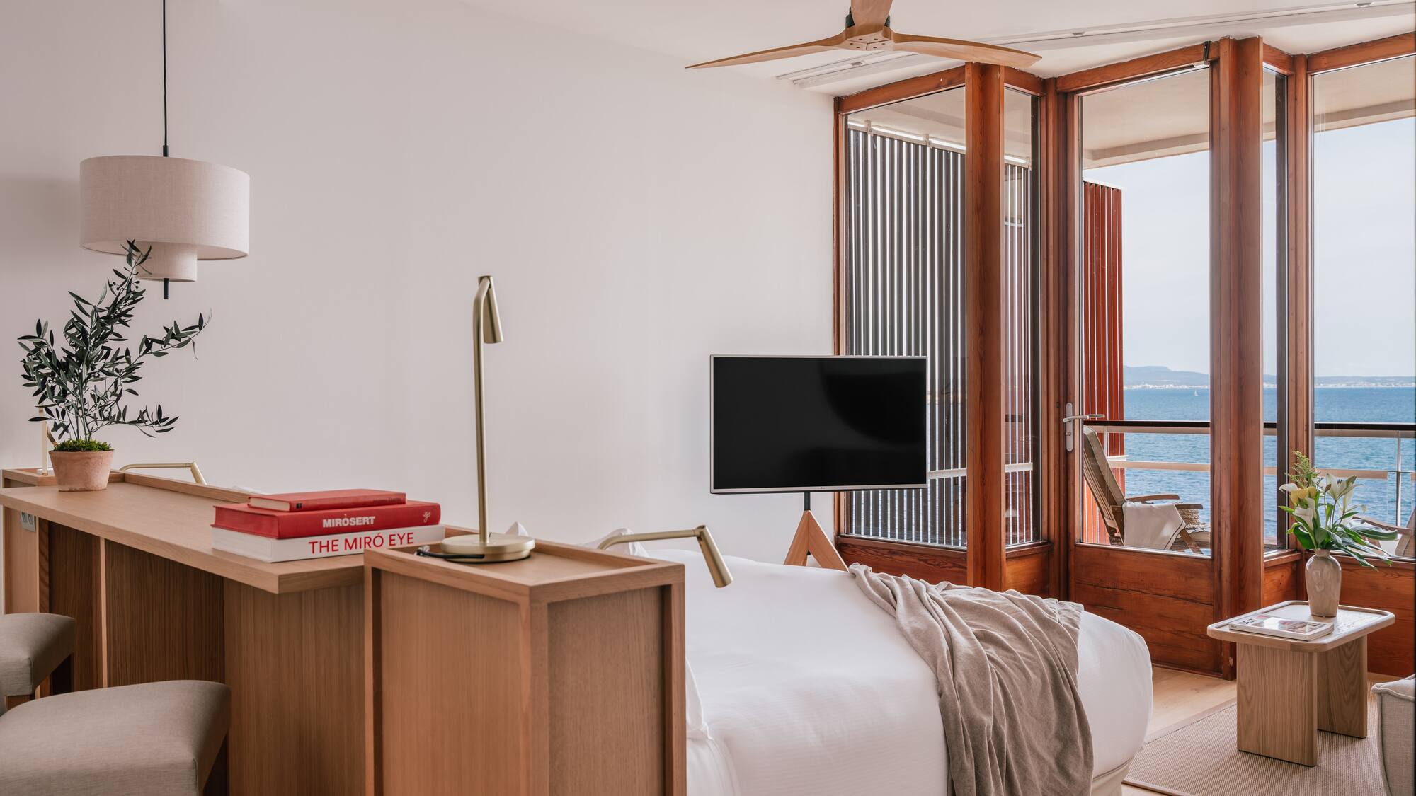 a room with a bed and a table and a window