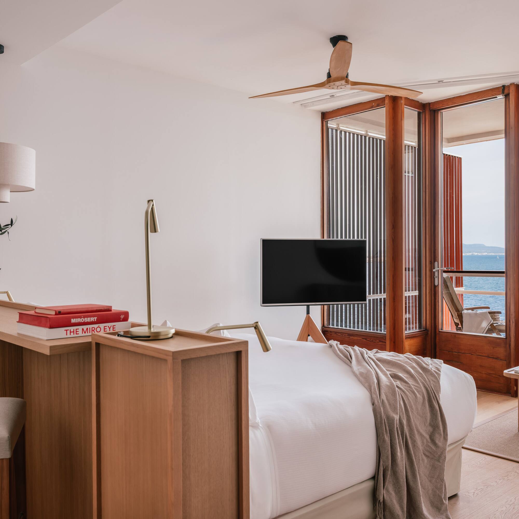 a room with a bed and a table and a window