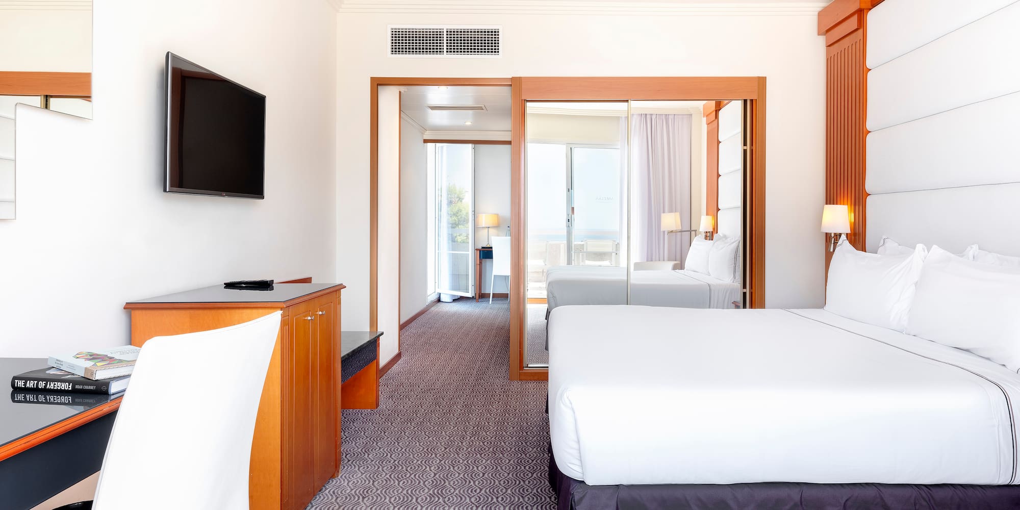 a room with a bed and a television