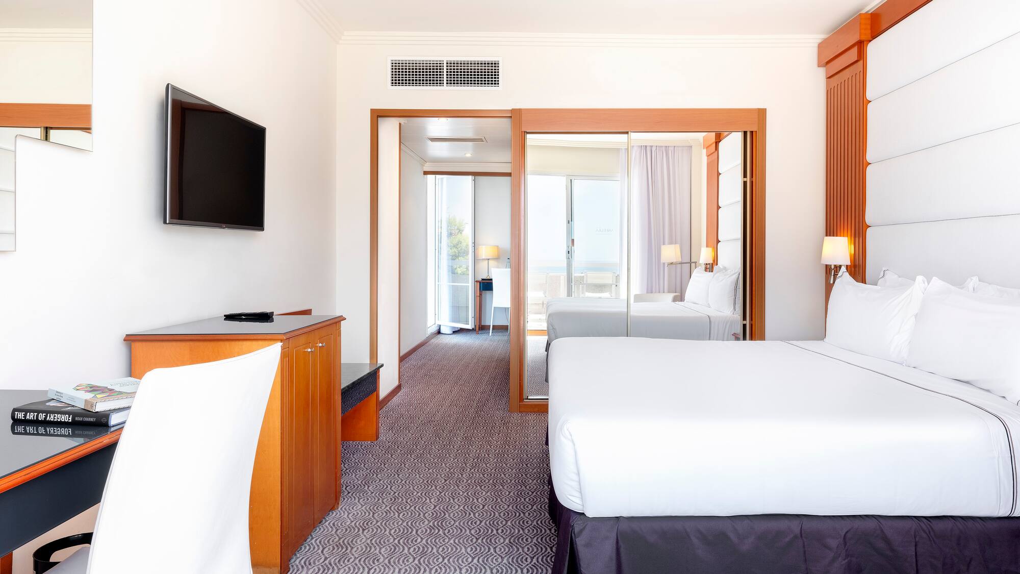 a room with a bed and a television