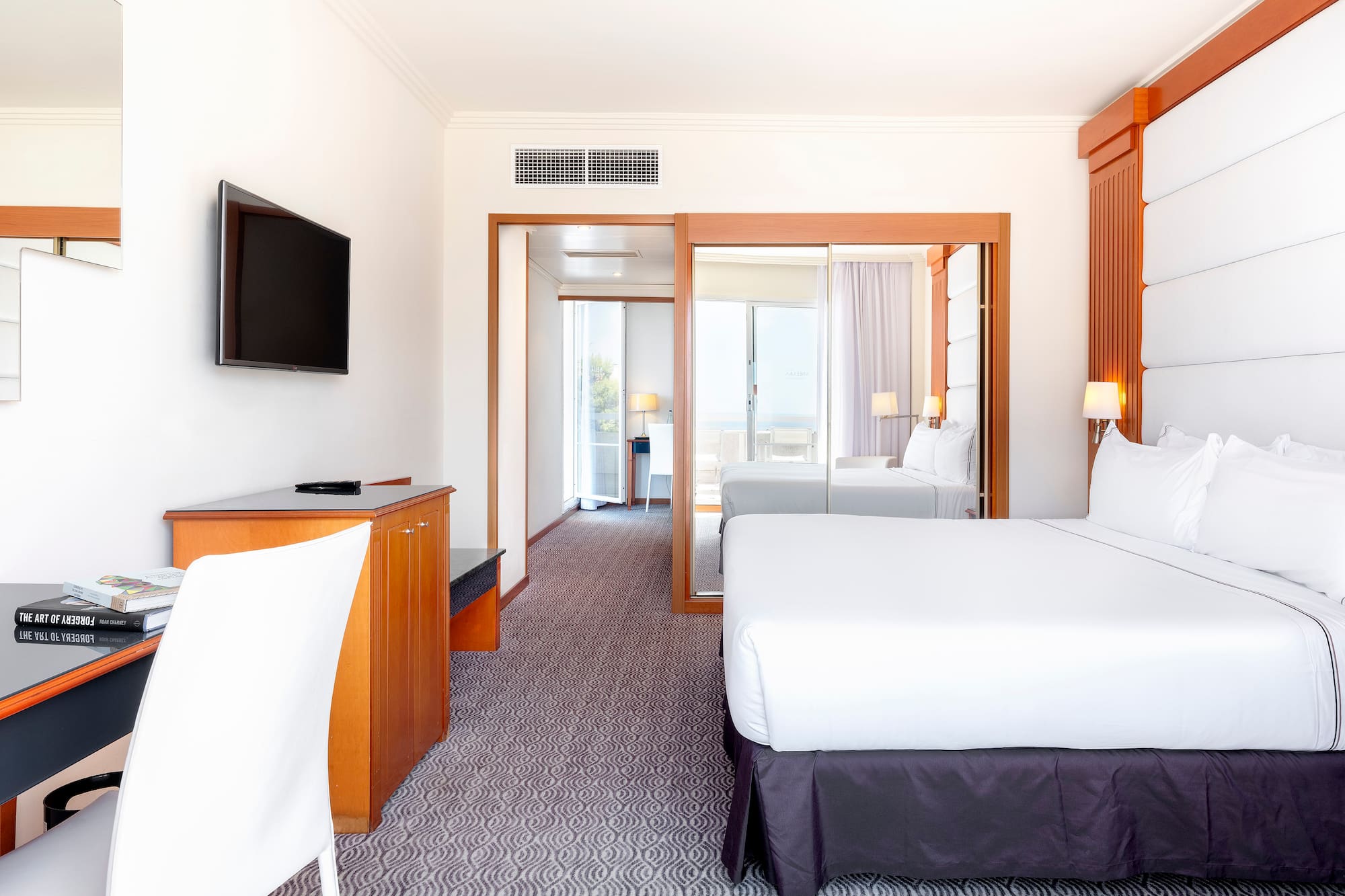 a room with a bed and a television