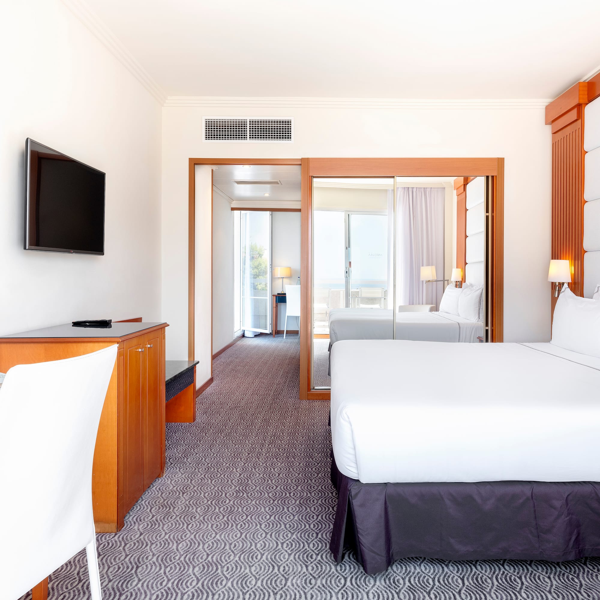 a room with a bed and a television