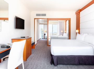 a room with a bed and a television