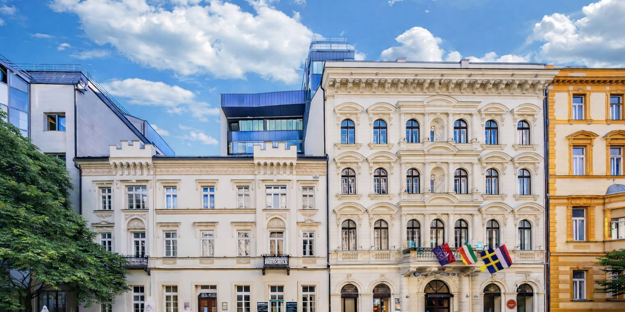 a building with many windows and flags