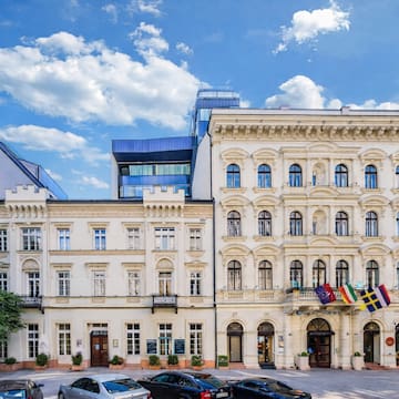 a building with many windows and flags
