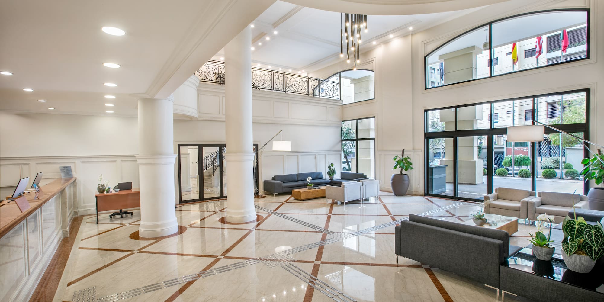 a large room with white columns and a couch