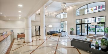 a large room with white columns and a couch