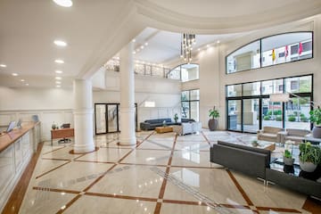 a large room with white columns and a couch