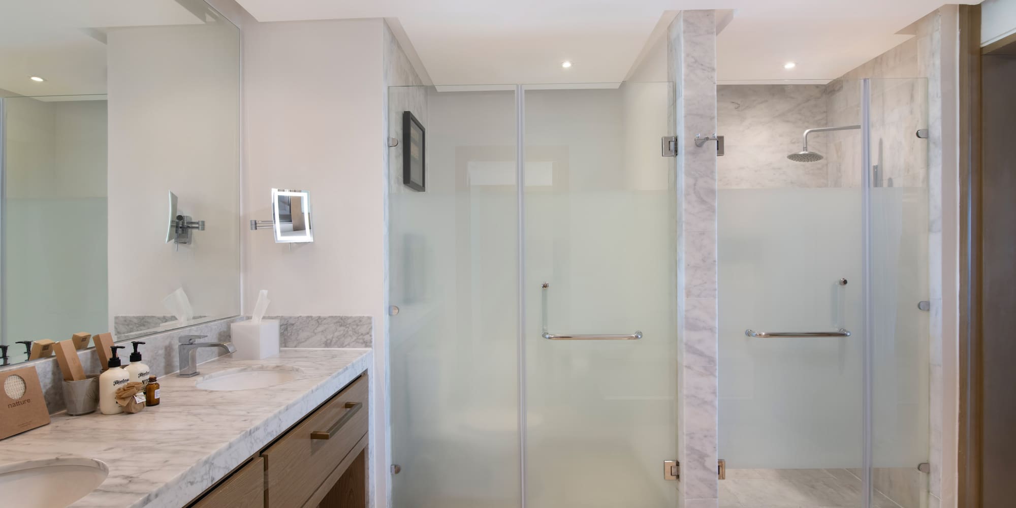 a bathroom with a glass shower and sink