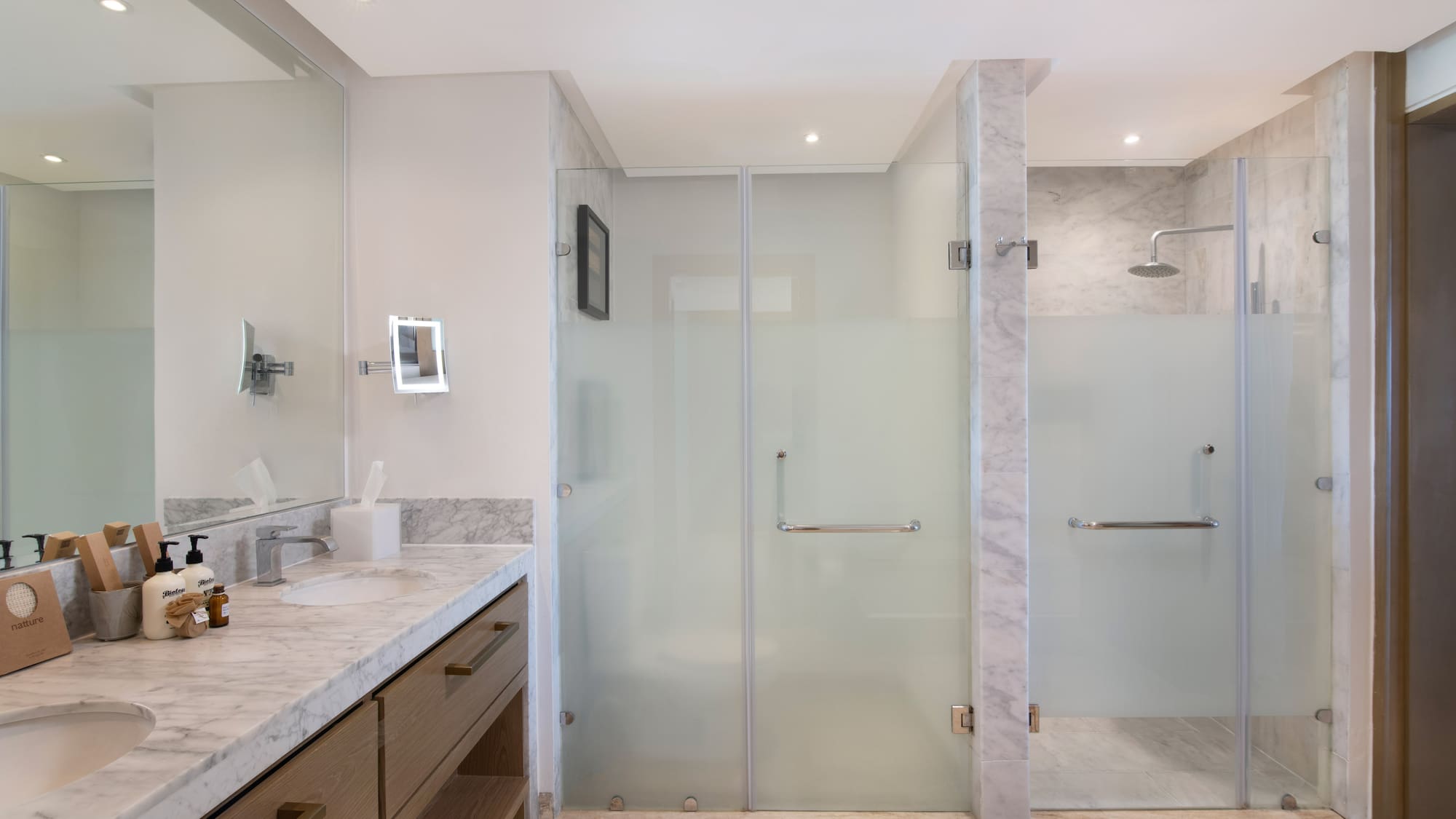a bathroom with a glass shower and sink