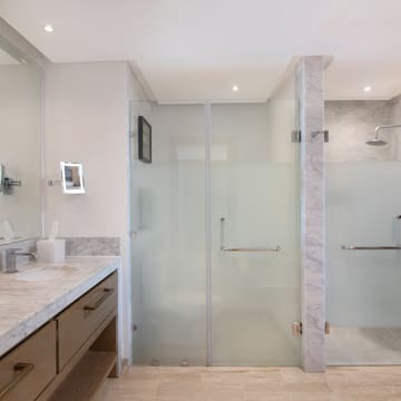 a bathroom with a glass shower and sink