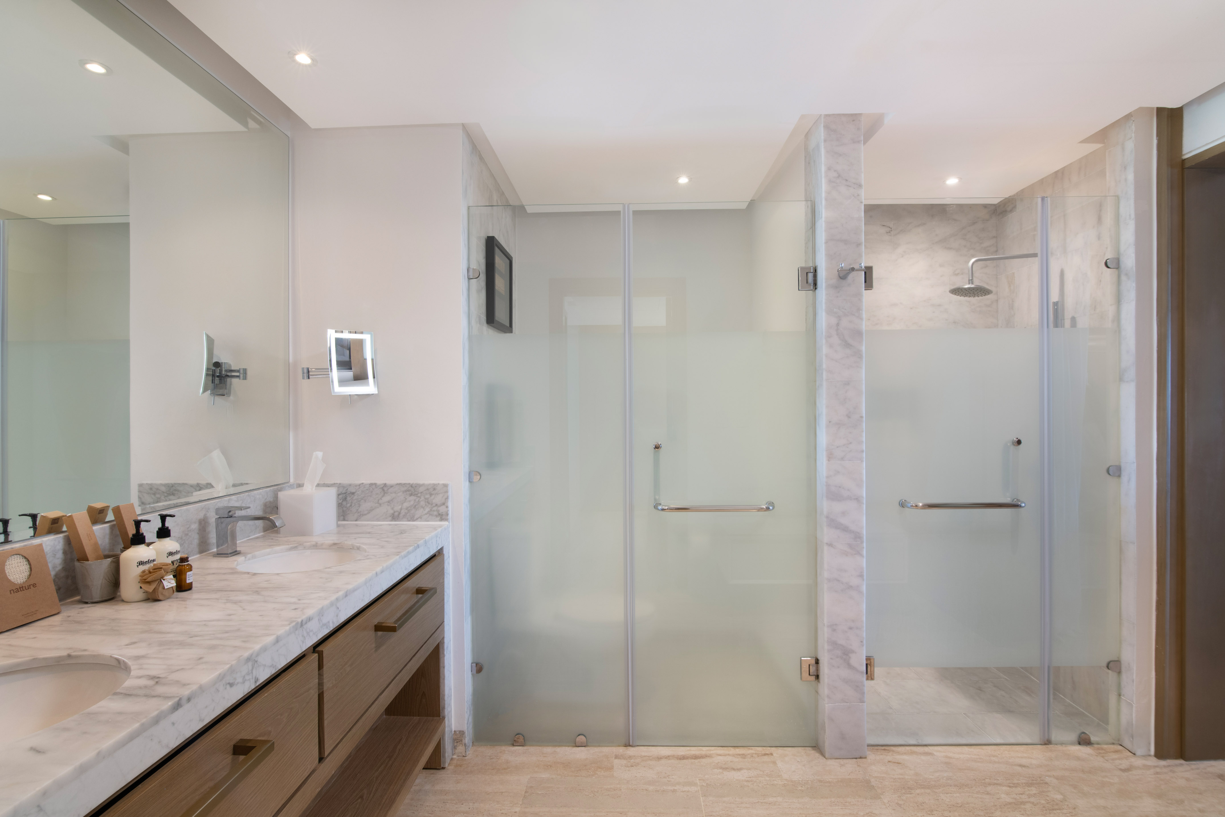 a bathroom with a glass shower and sink