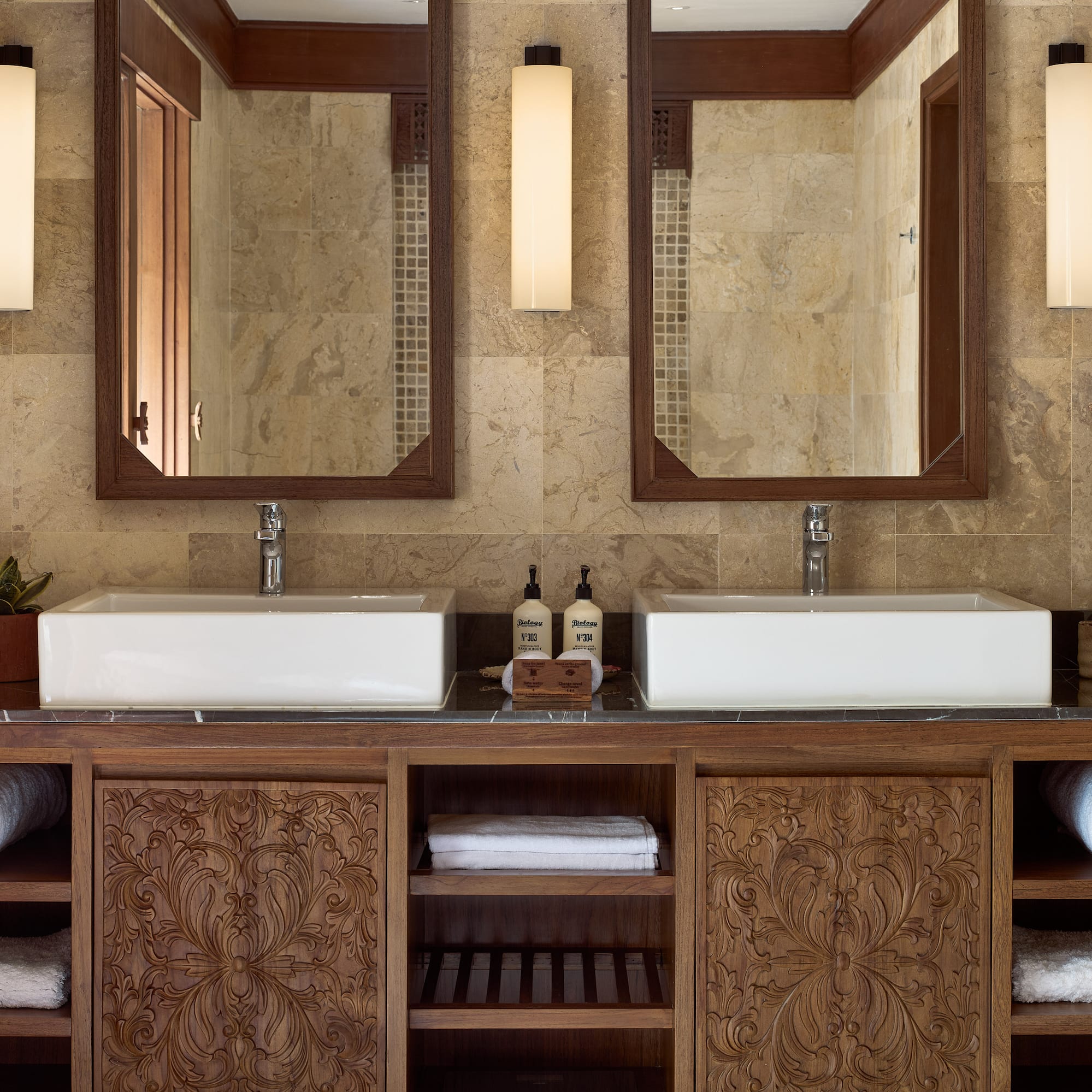 a bathroom with double sinks and mirrors