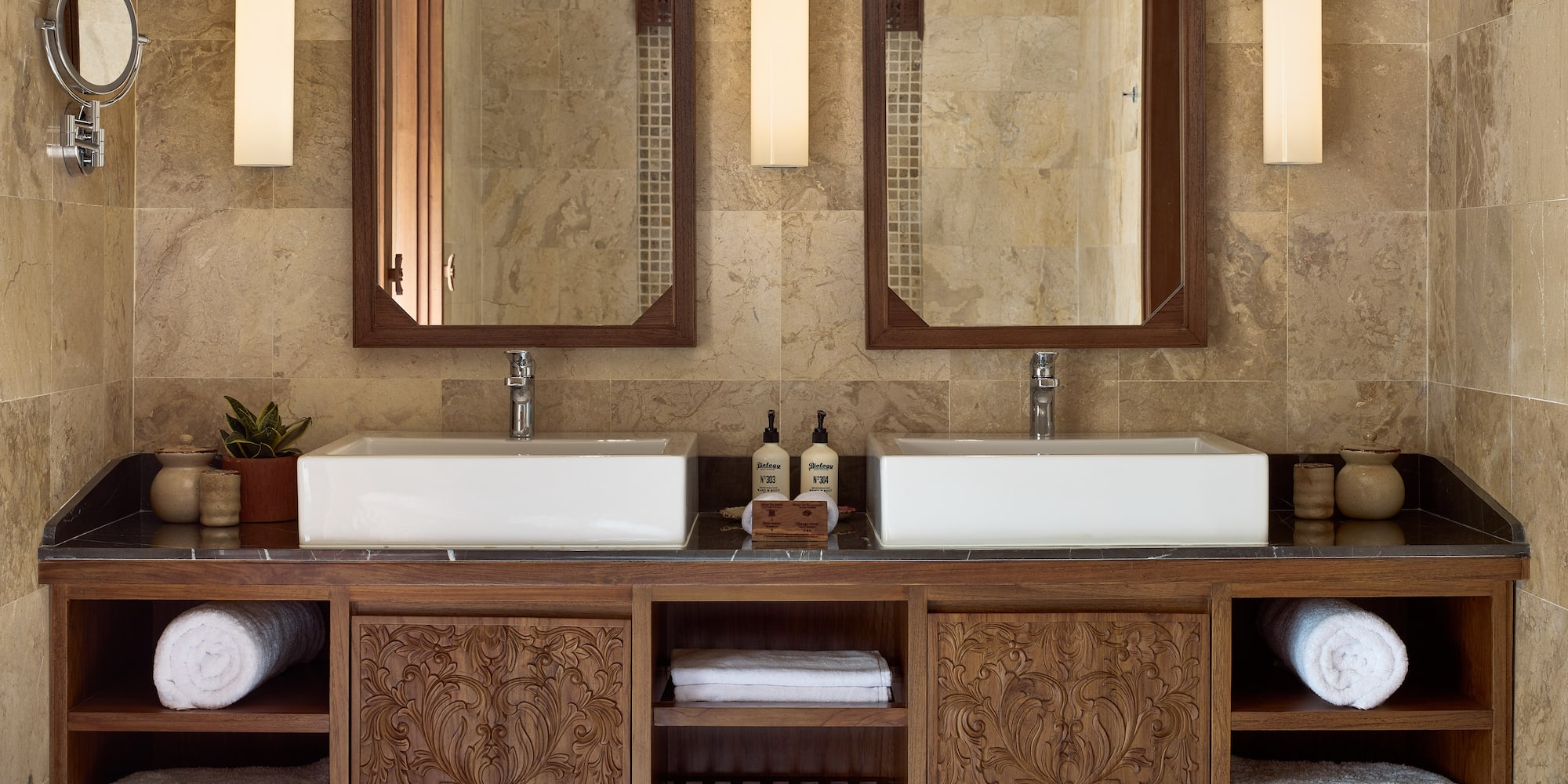 a bathroom with double sinks and mirrors