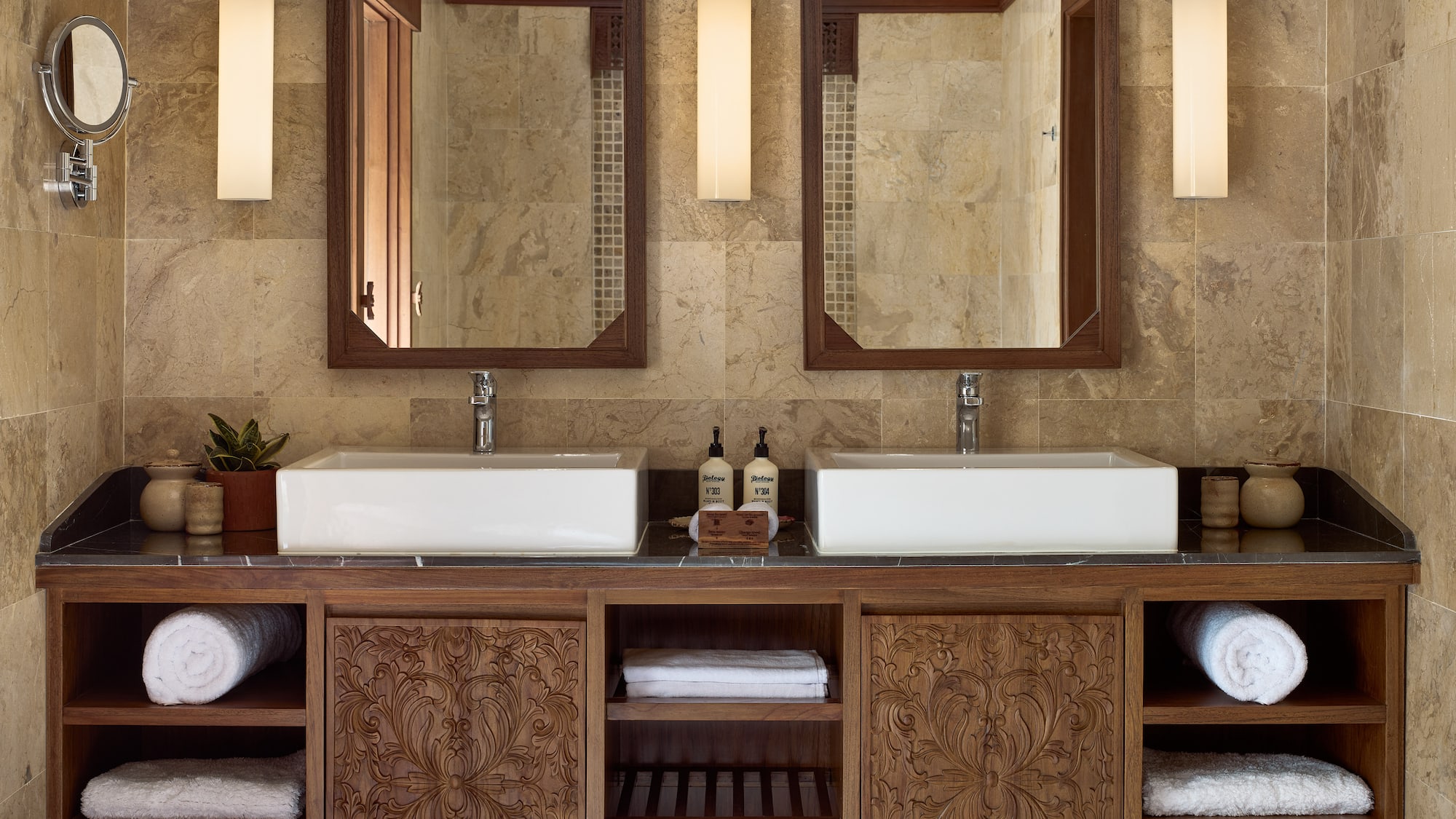 a bathroom with double sinks and mirrors