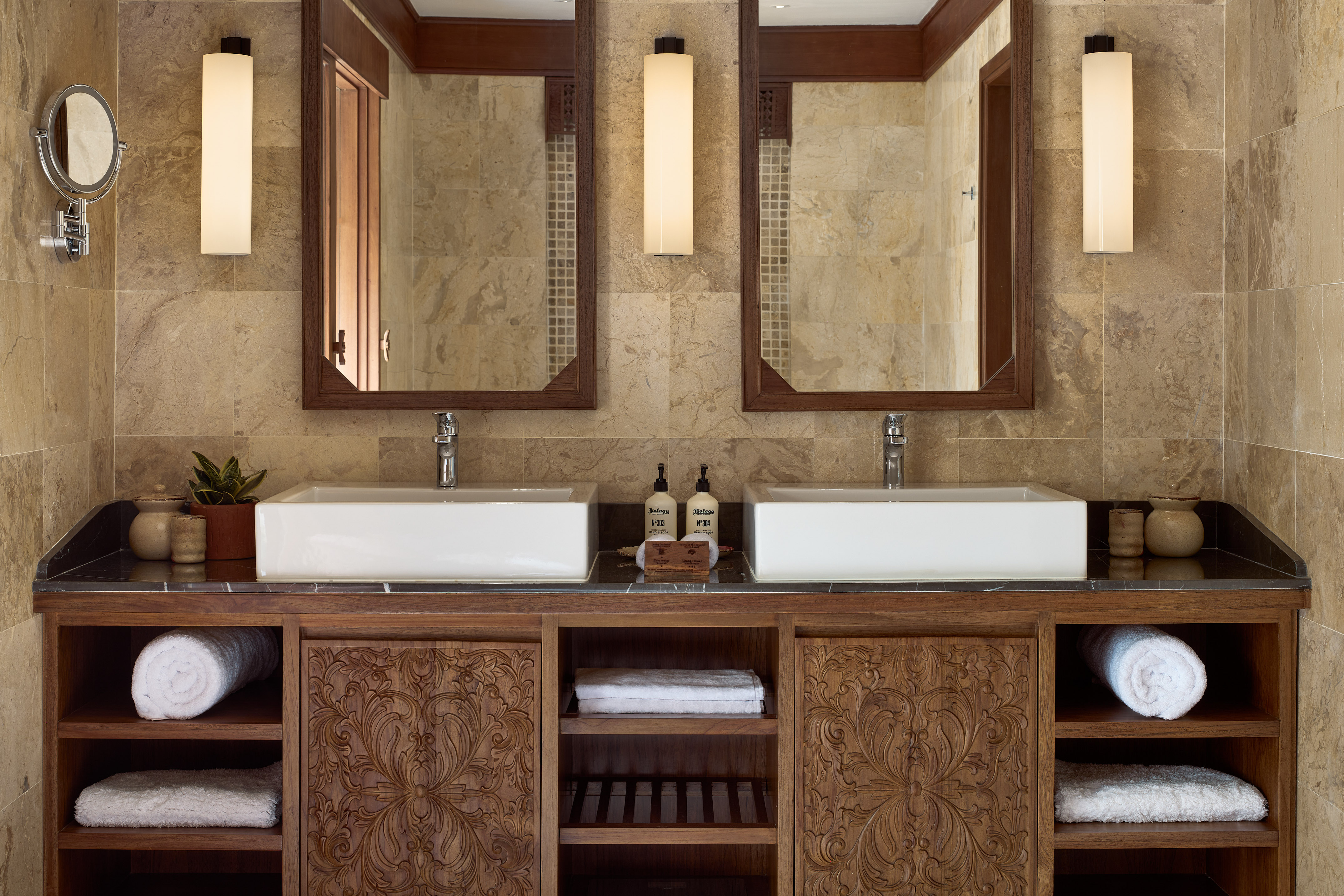 a bathroom with double sinks and mirrors