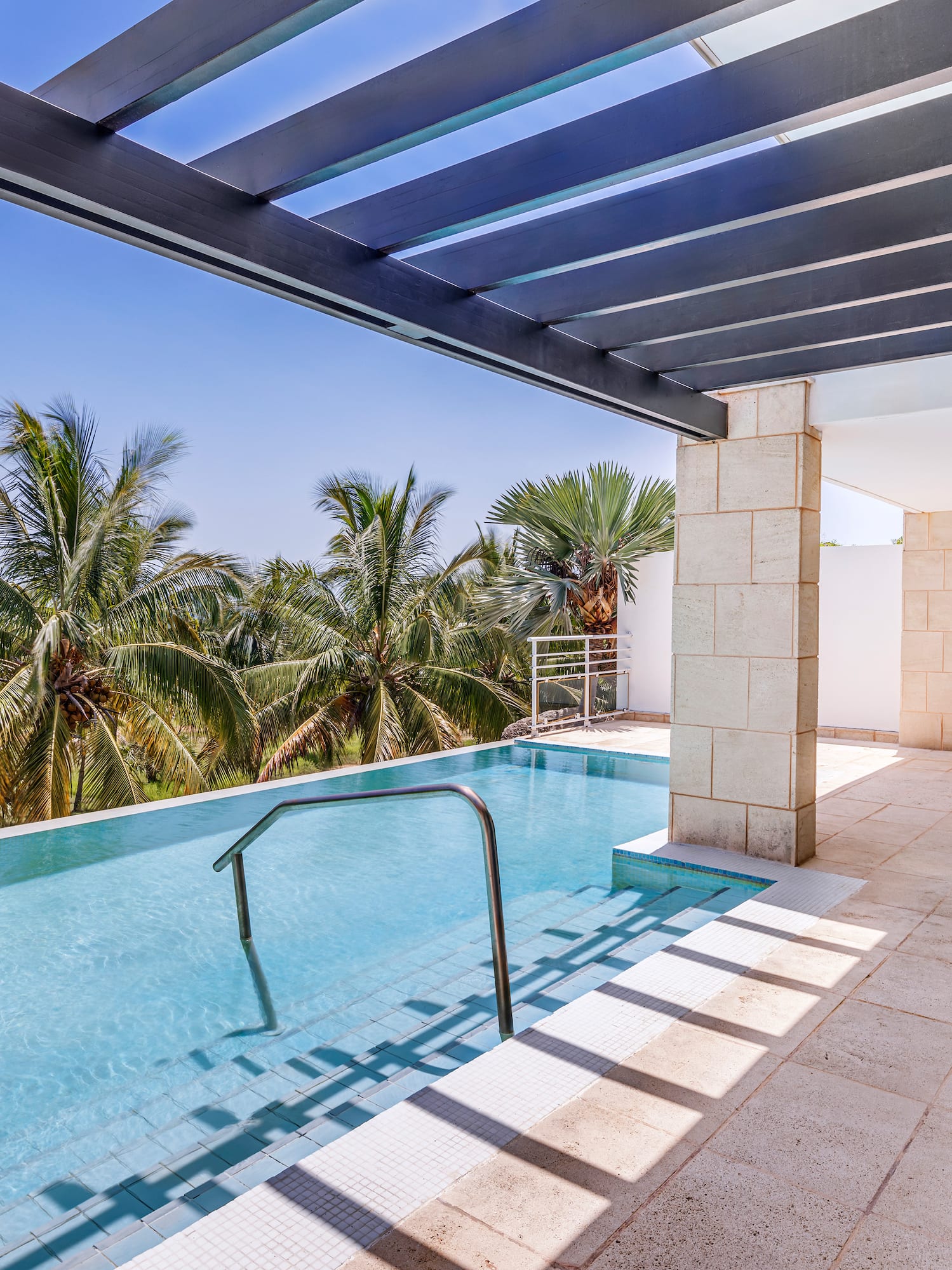 a pool with a deck and a chair