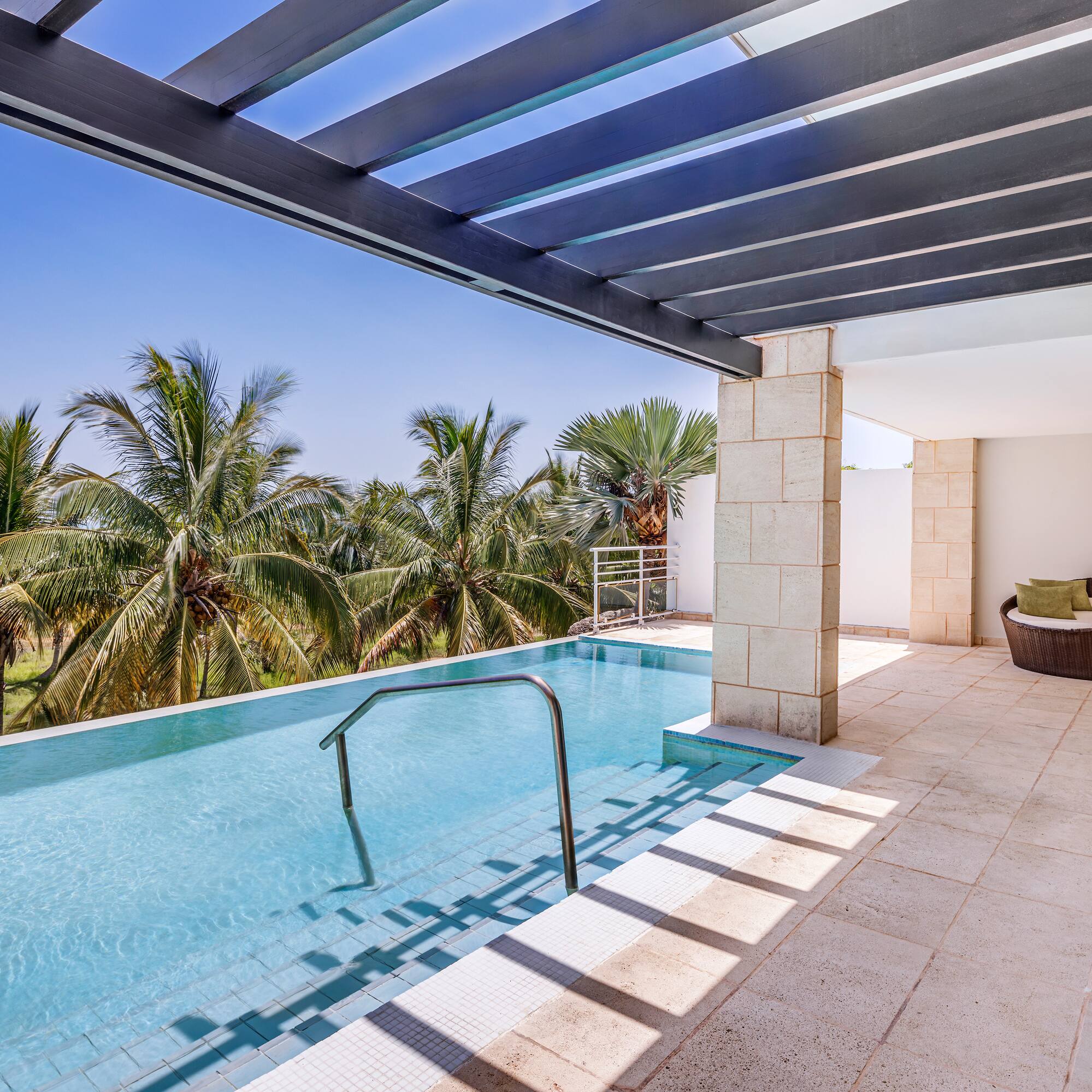 a pool with a deck and a chair