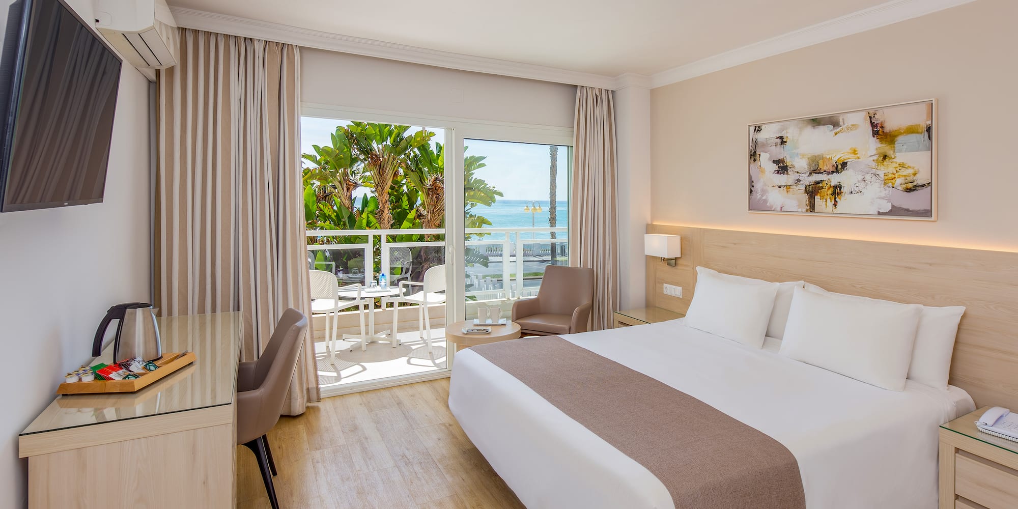 a room with a bed and a desk and chairs