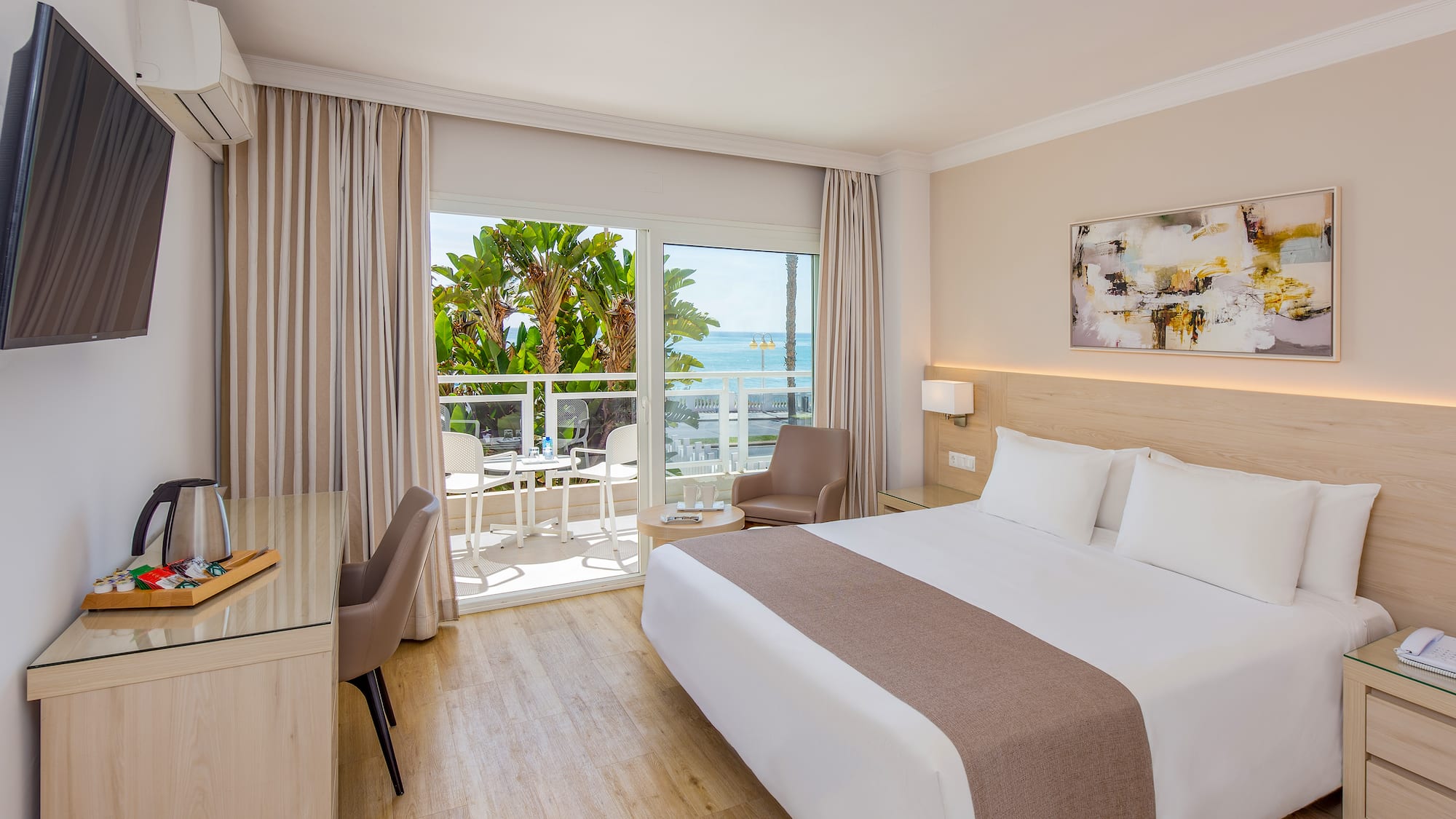 a room with a bed and a desk and chairs