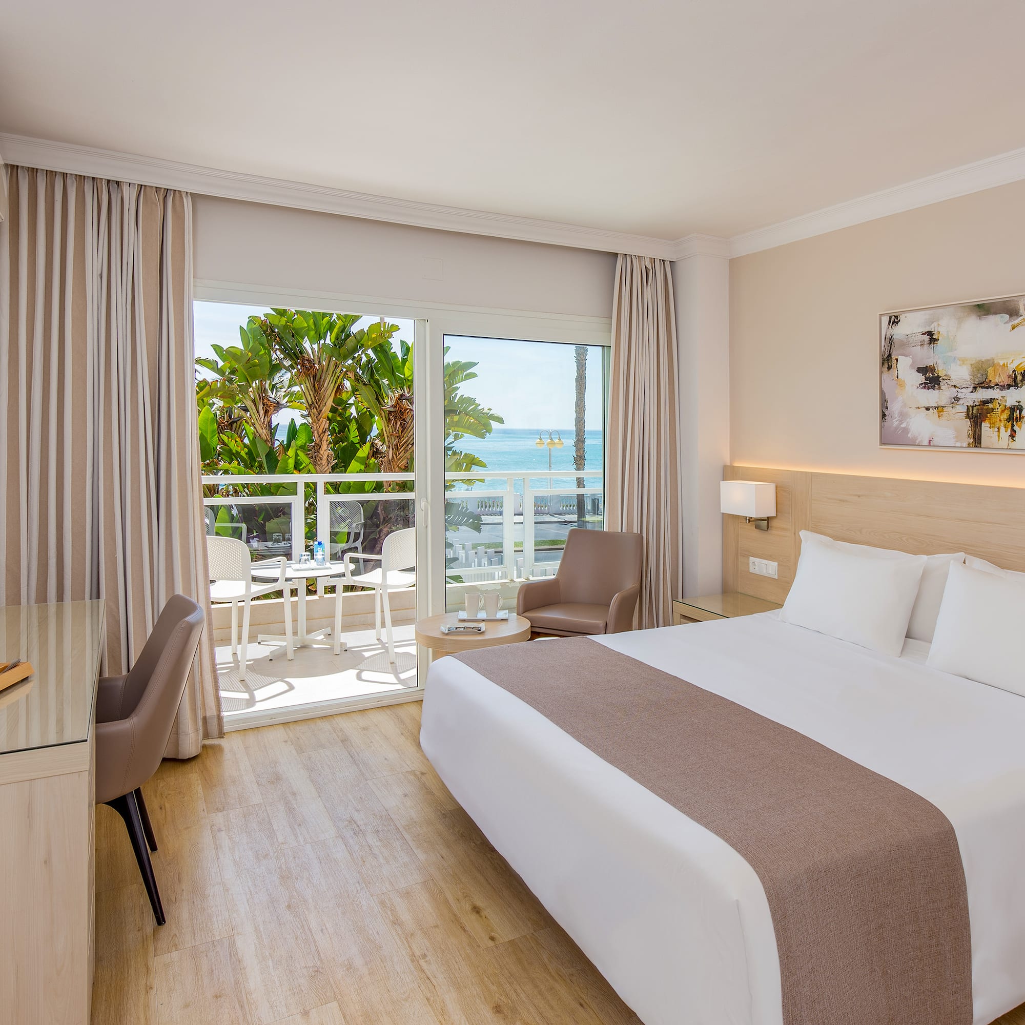 a room with a bed and a desk and chairs