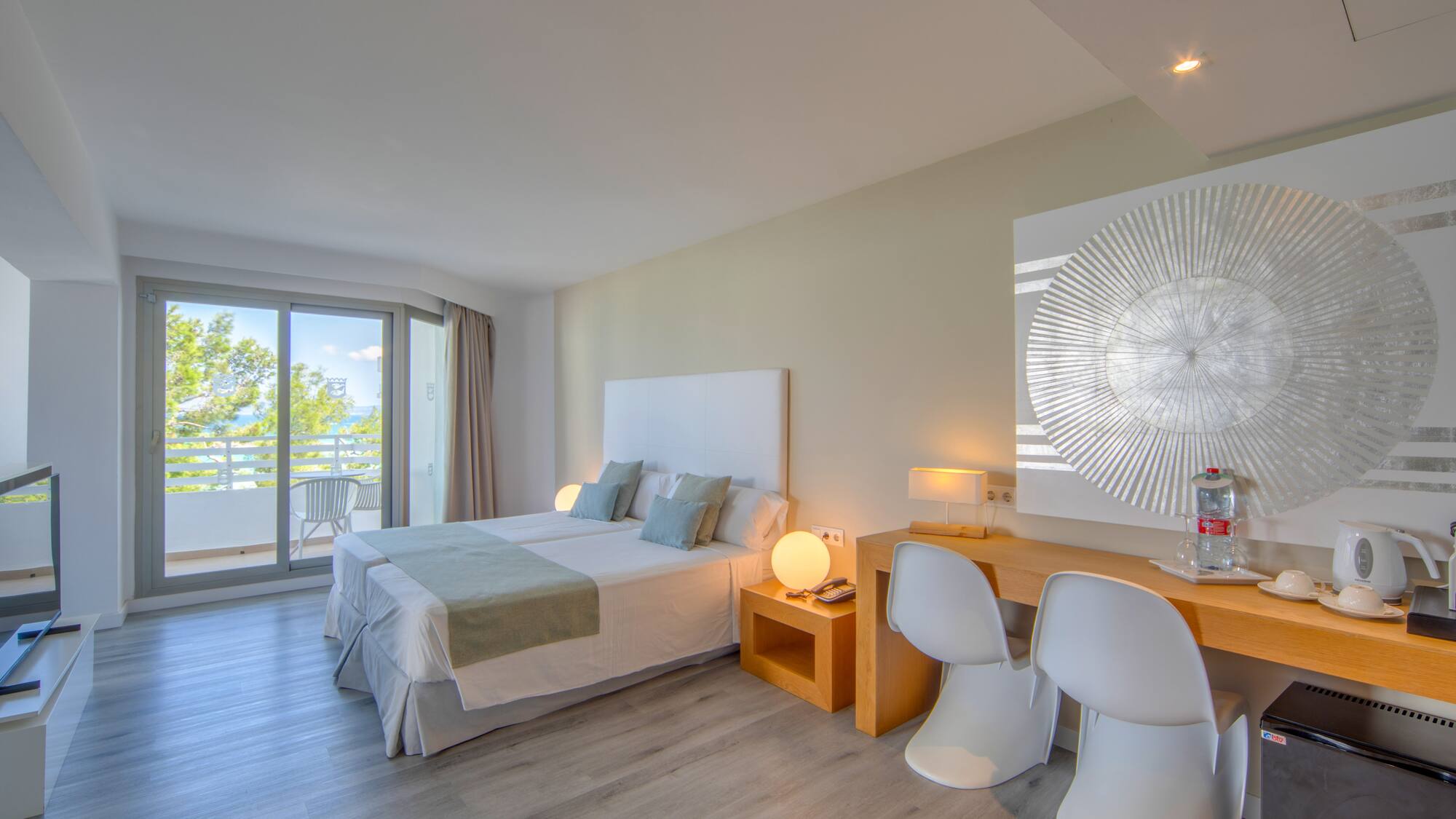 a room with a bed and a desk and chairs