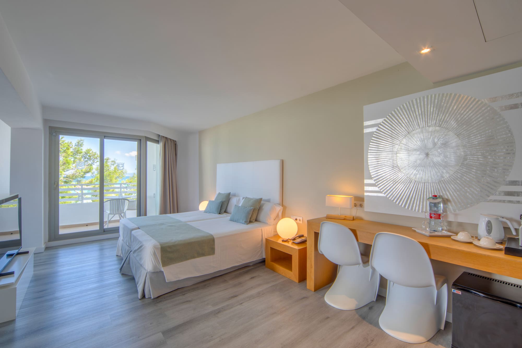 a room with a bed and a desk and chairs