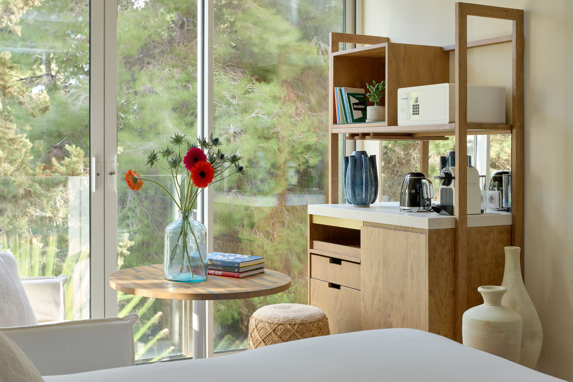 a room with a table and a coffee maker and a window