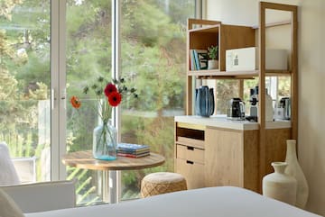 a room with a table and a coffee maker and a window