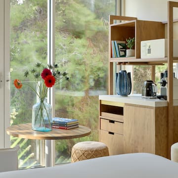 a room with a table and a coffee maker and a window