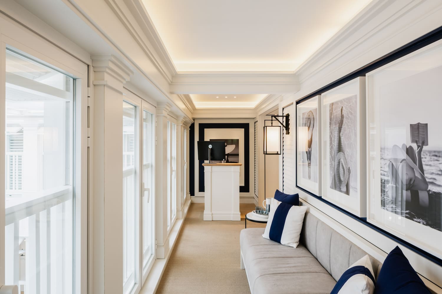 a long hallway with a couch and art on the wall